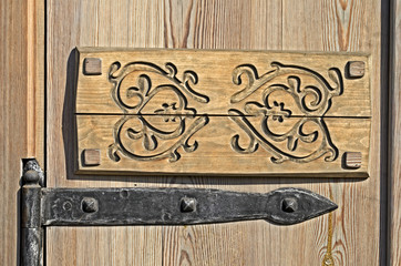 Old metallic hinge on wooden door