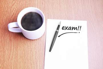 Coffee, pen and notes write exam