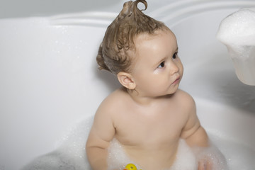 Little kid with mohawk play in tub