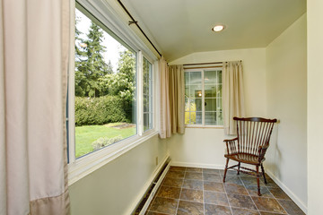 Lovely side room with green pastel walls, and a wooden chair.