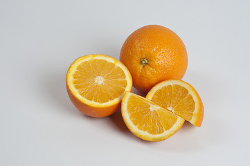 cutting fresh oranges fruit on white background	