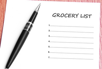 Pen  and notes paper with grocery list