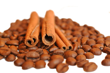 coffee beans witn cinnamon sticks on white