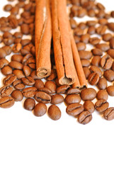 coffee beans witn cinnamon sticks on white