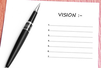 Pen  and notes paper with vision list