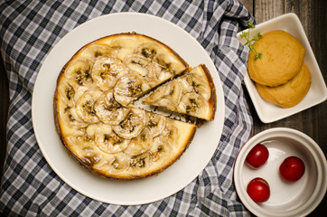 Homemade banana caramel cheesecake on beautiful fabric background