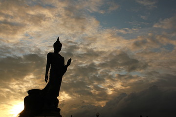 Big Buddha statue on sunset sky.