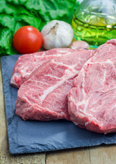Raw beef steak on a black slate tray
