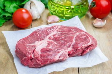 Raw beef steak on a parchment paper