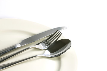 close up dinning silverware fork , spoon and knife with dish 