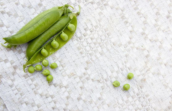 Green peas on the vintage linen background