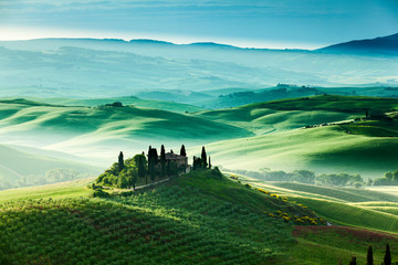 The fairytale landscape of Tuscany fields at sunrise