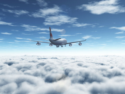 A passenger plane flying above the clouds
