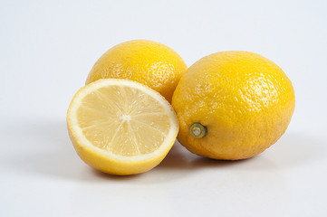 three yellow cutting lemon on white background