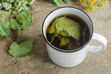 A mug of herbal tea (infusion) with dried black currant leaves