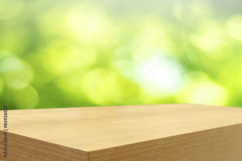 Poster empty wooden table and green natural spring blur bokeh backgroun