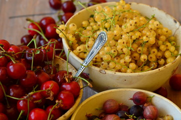 Cherries, currants and gooseberries in vintage bowls