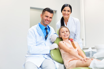 Obraz premium Dentist Team and Happy Patient at Dental Clinic