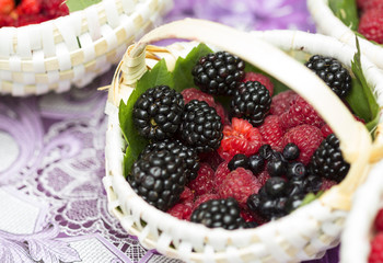 Mulberry and raspberries in wicker baskets