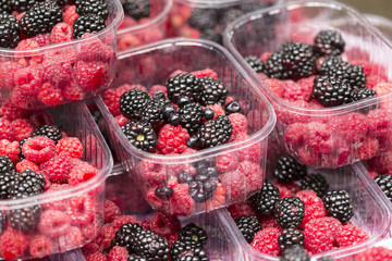 Mulberry and raspberries in transparent cups