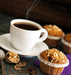 Muffin cakes in silver tray with cup of coffee