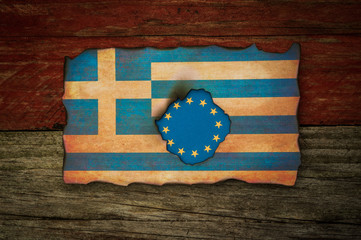 European flag behind burnt Greek flag grunge background