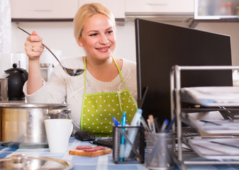 freelancer with dishware working on PC