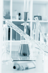 pipette and chemical glass in laboratory blue color