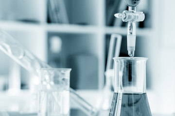 pipette and chemical glass in laboratory blue color