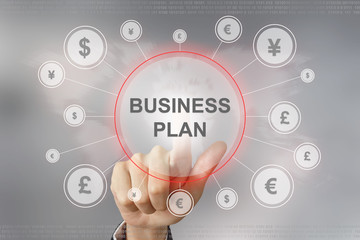 business hand pushing business plan button
