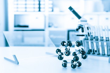 microscope with model of molecule