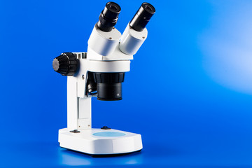 Binocular microscope on blue background