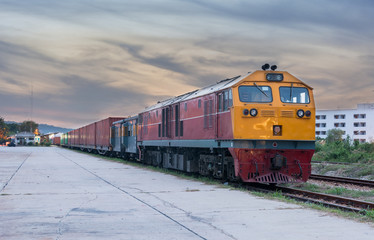 Fototapeta premium Cargo train and container at twilight