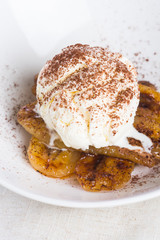pan fried banana topped with vanilla ice cream and cocoa powder