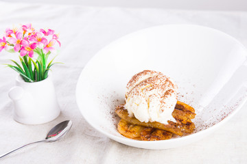 pan fried banana topped with vanilla ice cream and cocoa powder