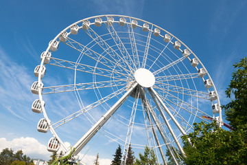 white ferris wheel against blue sky background