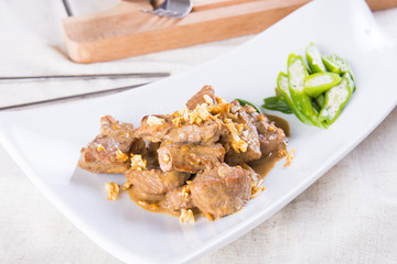 beef salpicao, or beef with creamy soy sauce topped with toasted garlic