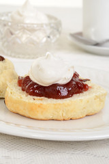 Obraz na płótnie Canvas closeup of scone with cream and jam