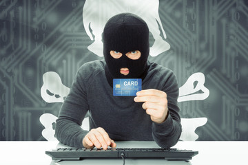 Hacker holding credit card and flag on background - Jolly Roger