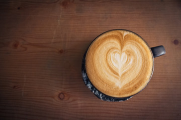 cup of coffee top view surface heart shape in wooden background