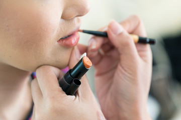 orange lipstick of makeup with cosmetic for woman