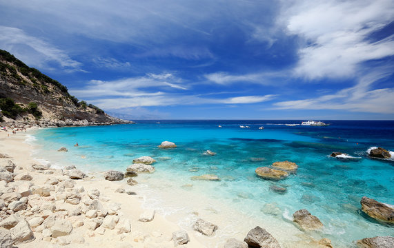 Cala Mariolu on a clear day with soft white clouds, Sardinia