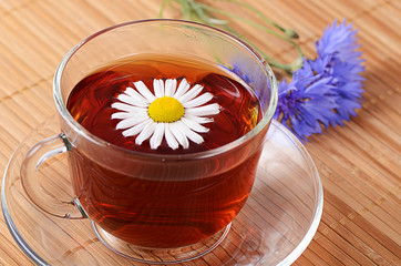 Herbal teas in cup with chamomile
