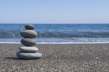 Fototapeta na wymiar Balance stones on the beach. Selective focus