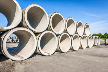 Big concrete sewage pipes stored in a factory - obrazy, fototapety, plakaty