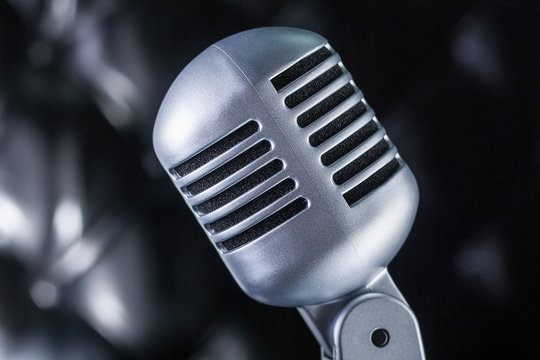Grey vintage microphone on black  background
