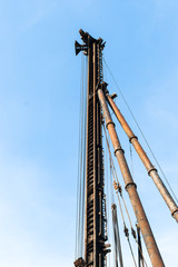 Obraz premium derrick in construction area against the bright blue sky