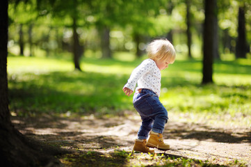 Toddler boy walking in the park