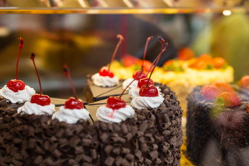 Cherry Topped Chocolate Cake in Window Display