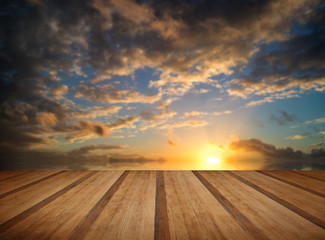 Stunning colorful Winter sunset sky with wooden planks floor